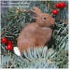 Hand painted Cottontail Rabbit sitting Christmas ornament.