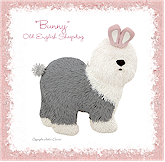 Old English Sheepdog with bunny ears and tail.