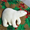 Hand painted polar bear Christmas ornament on holly cloth.